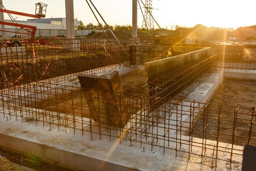 Construction site with concrete and steel and crane lifting equipment