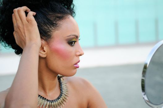 Portrait of beautiful black girl with mirror