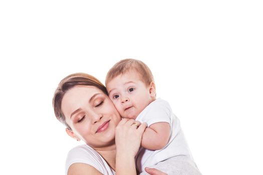 Portrait of happy mother and child embracing cheek to cheek on a white background. Mother with closed eyes holding baby's hand