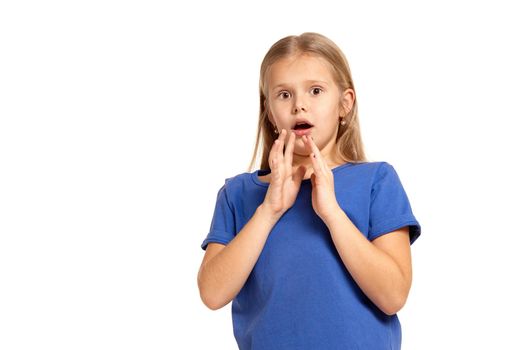 Portrait of adorable little girl isolated on a white background. in blue t-short with long white hair, worried, keepig her palms tight