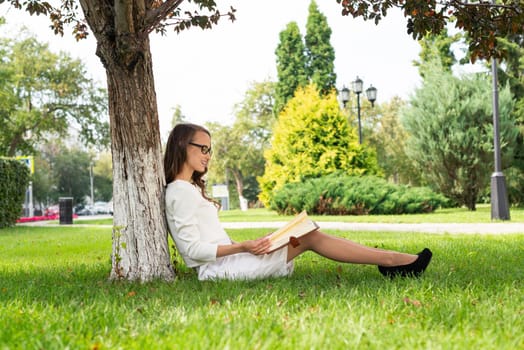 Beautiful young woman study with notepad in park