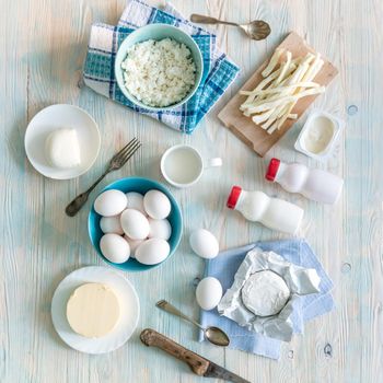 set of dairy products on wooden background top view