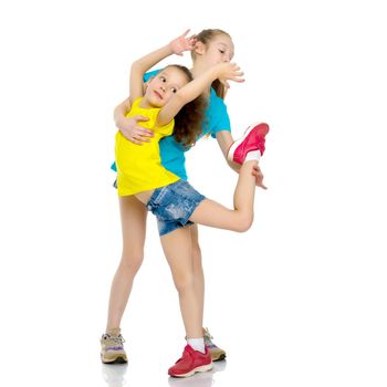 Lovely little girls gymnasts warm up before the competition. The concept of a happy childhood, sports and fitness. Isolated on white background.