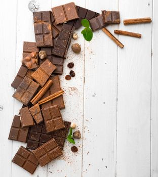 variety of chocolate on a wooden background with space for text