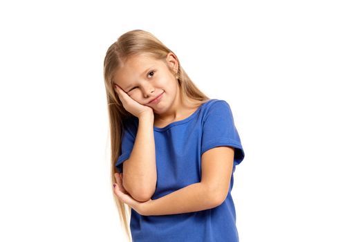 Portrait of adorable little girl isolated on a white background. in blue t-short with long white hair, holding her head