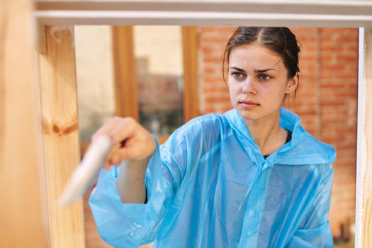 woman painter in protective clothing renovation design house. High quality photo