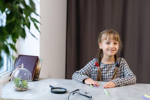 Little girl concentrated while doing her homework