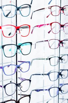 Closeup view of different colorful glasses for kinds on the showcase in the optical store