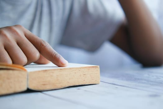 close up of young man hand reading a book ,