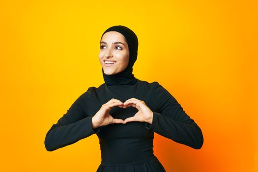 pretty woman in black hijab posing fashion hand gesture isolated background. High quality photo