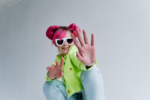 cheerful woman pink hair posing fashion clothes studio model. High quality photo
