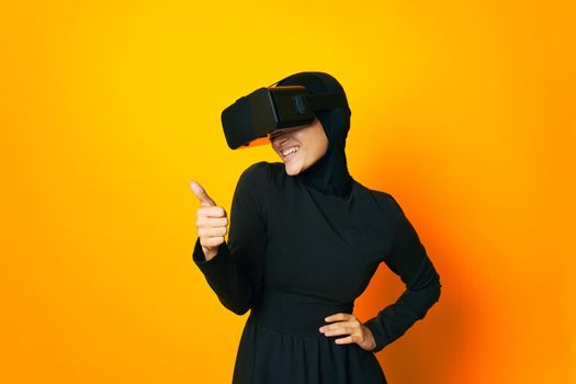 pretty woman in black hijab VR glasses emotions isolated background. High quality photo