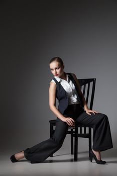 Mafiosi woman over dark grey background. Fashion photo. Retro style