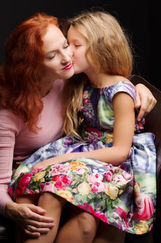 Young mother and little daughter gently embrace. The concept of Happy Childhood, Family Happiness, Raising a Child.