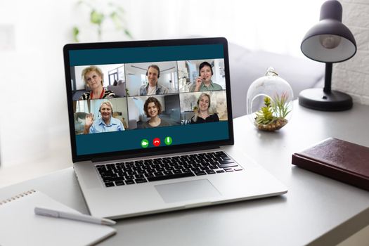 Virtual meeting online. Video conference by laptop. Online business meeting. On the laptop screen, people who gathered in a video conference to work on-line.