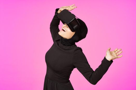 woman in black hijab glasses virtual reality technology movie watching. High quality photo