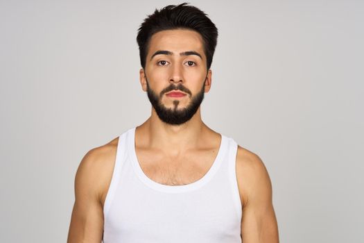 bearded man in white tank top cropped view Studio Model. High quality photo
