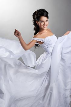 Fiance in the wind. Pretty lady in a flying wedding dress