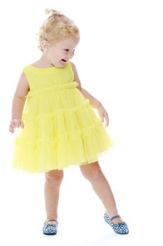 Little girl in a yellow dress. Isolated on white background .