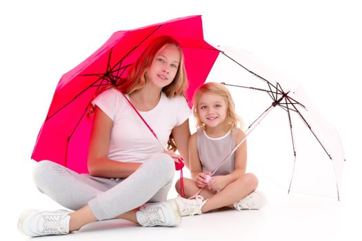 Lovely little girls hid under the umbrella. The concept of a happy childhood, family vacation. Isolated on white background.