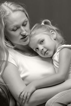 Young mother and little daughter gently embrace. The concept of Happy Childhood, Family Happiness, Raising a Child.