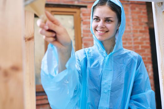 woman painter painting wood home renovation texture. High quality photo