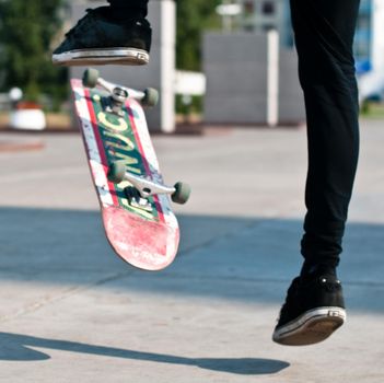 young skater perfoming stunt on his board