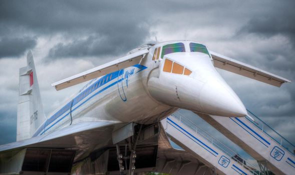 supersonic jet plane on the ground boarding with dramatic sky in background