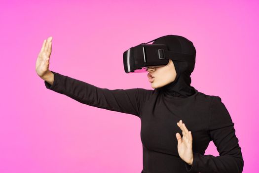 muslim woman wearing virtual reality glasses entertainment technology device. High quality photo
