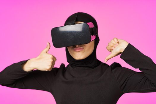 muslim woman wearing virtual reality glasses entertainment technology device. High quality photo
