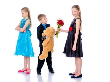 A little boy gives a little girl flowers. The concept of a happy childhood, love. Isolated on white background.