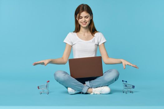 woman with laptop learning internet online education blue background. High quality photo
