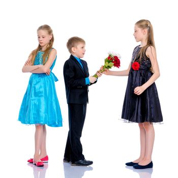 A little boy gives a little girl flowers. The concept of a happy childhood, love. Isolated on white background.