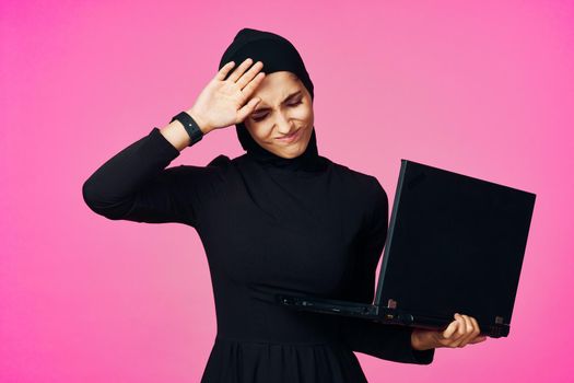 cheerful muslim woman with laptop education student internet technology. High quality photo