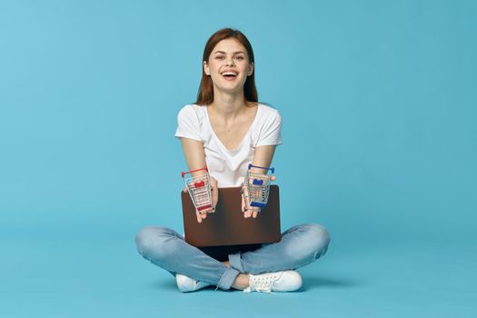 woman with laptop learning internet online education blue background. High quality photo
