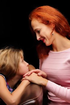 Young mother and little daughter gently embrace. The concept of Happy Childhood, Family Happiness, Raising a Child.