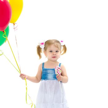 Little girl is playing with a balloon. The concept of the holiday, birthday. Isolated over white background