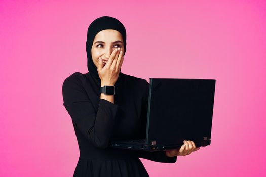 cheerful muslim woman with laptop education student internet technology. High quality photo