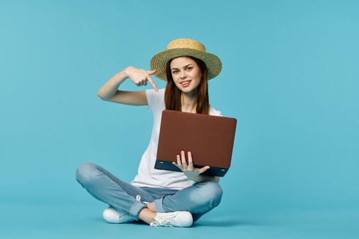 woman with laptop learning internet online education blue background. High quality photo