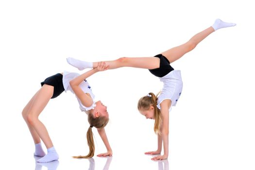 Girls gymnasts perform exercises. The concept of strength, health and sport. Isolated on white background.