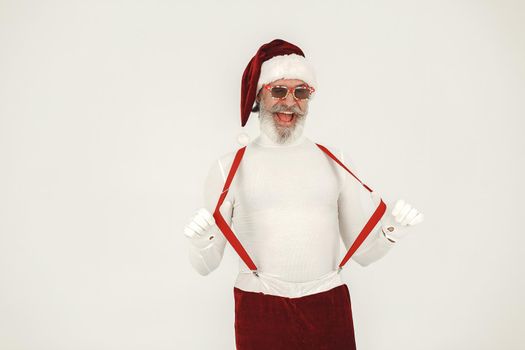 Trendy grey-haired santa. Man wear knitted clothes. Grandfather in a santa's hat.