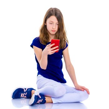 Happy little girl enjoys a smartphone. The concept of people and technology. Isolated on white background.