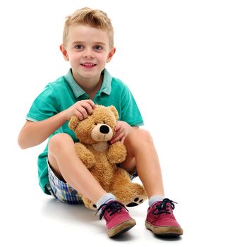 A little boy is playing with a teddy bear. The concept of a happy childhood, games, the development of a child in the family.