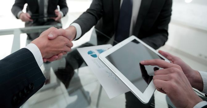 handshake business colleagues in office