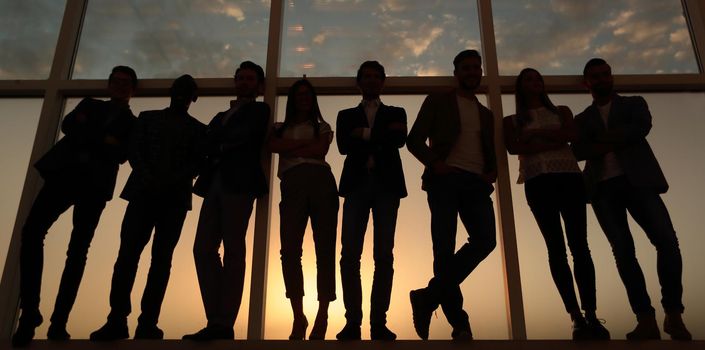 in full growth. business team standing near the office window.photo with copy space