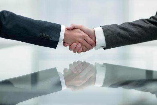 handshake business partners closeup in office