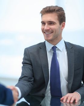 businessman extends his hand to his business partner.