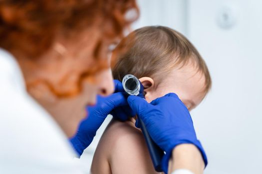 Pediatrician providing healthcare for her baby patient in the office of a specialized clinic for children. Neonatologist. Medical appointment little child one year old in the clinic. Health care of infant, children, kid.