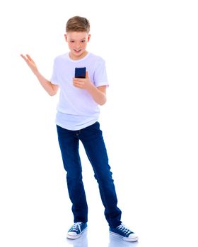 A small boy of school age uses a mobile phone. The concept of digital technology, communication between people. Isolated on white background.