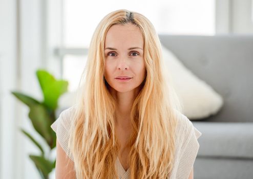 Portrait of pretty attractive blond girl without makeup at home. Natural beauty